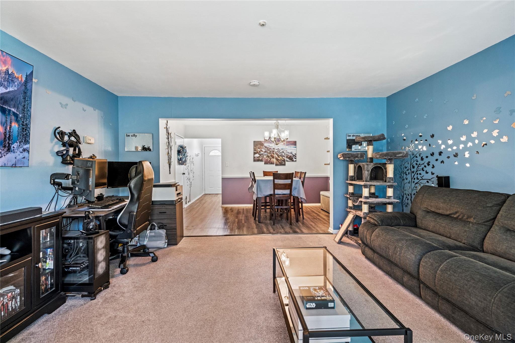 7 Maple Court, Unit 7 Selden, NY 11784 - Photo 13 of 18 a living room with furniture a dining table and a piano