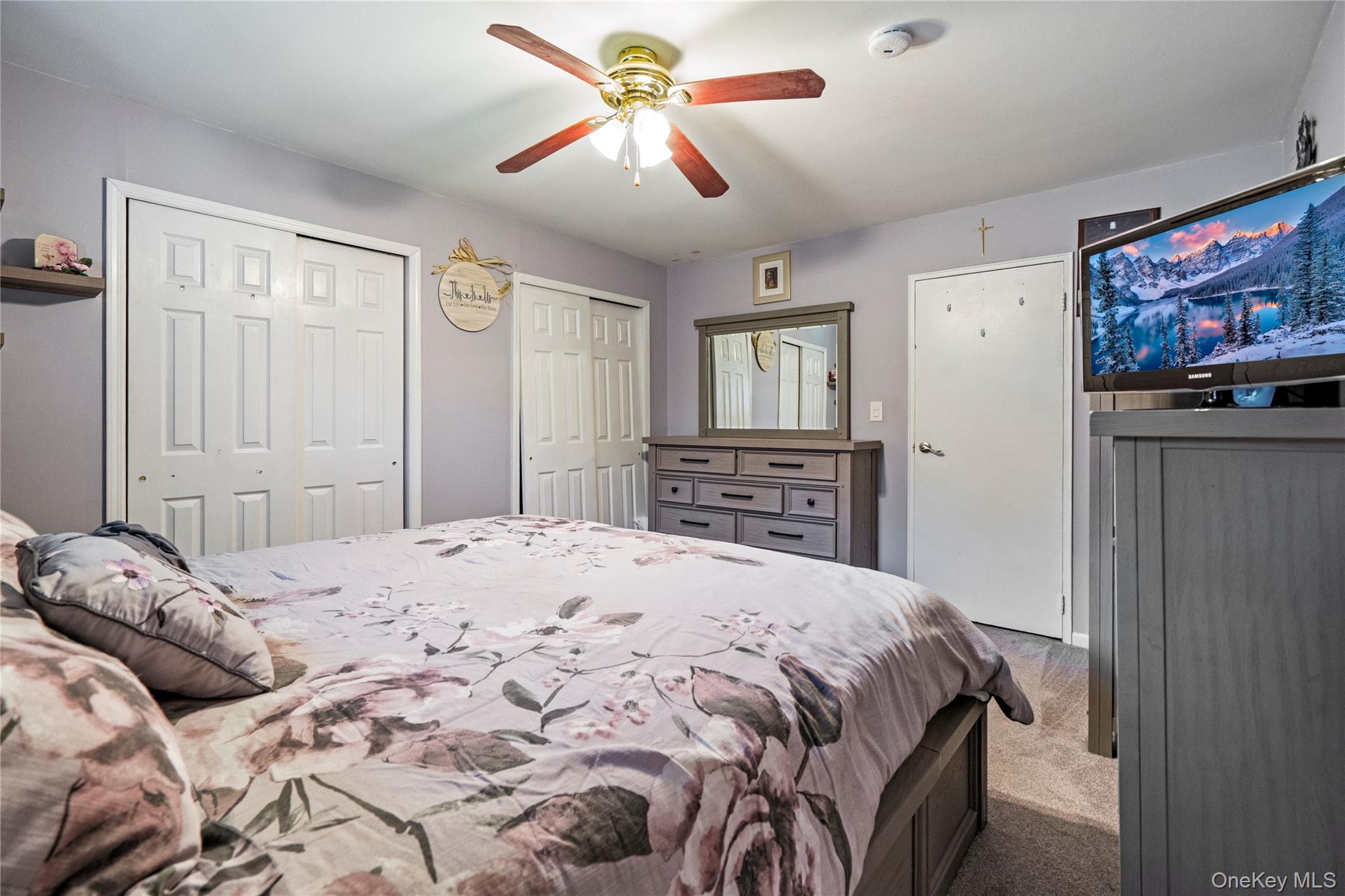 7 Maple Court, Unit 7 Selden, NY 11784 - Photo 15 of 18 a bedroom with a bed dresser and a window