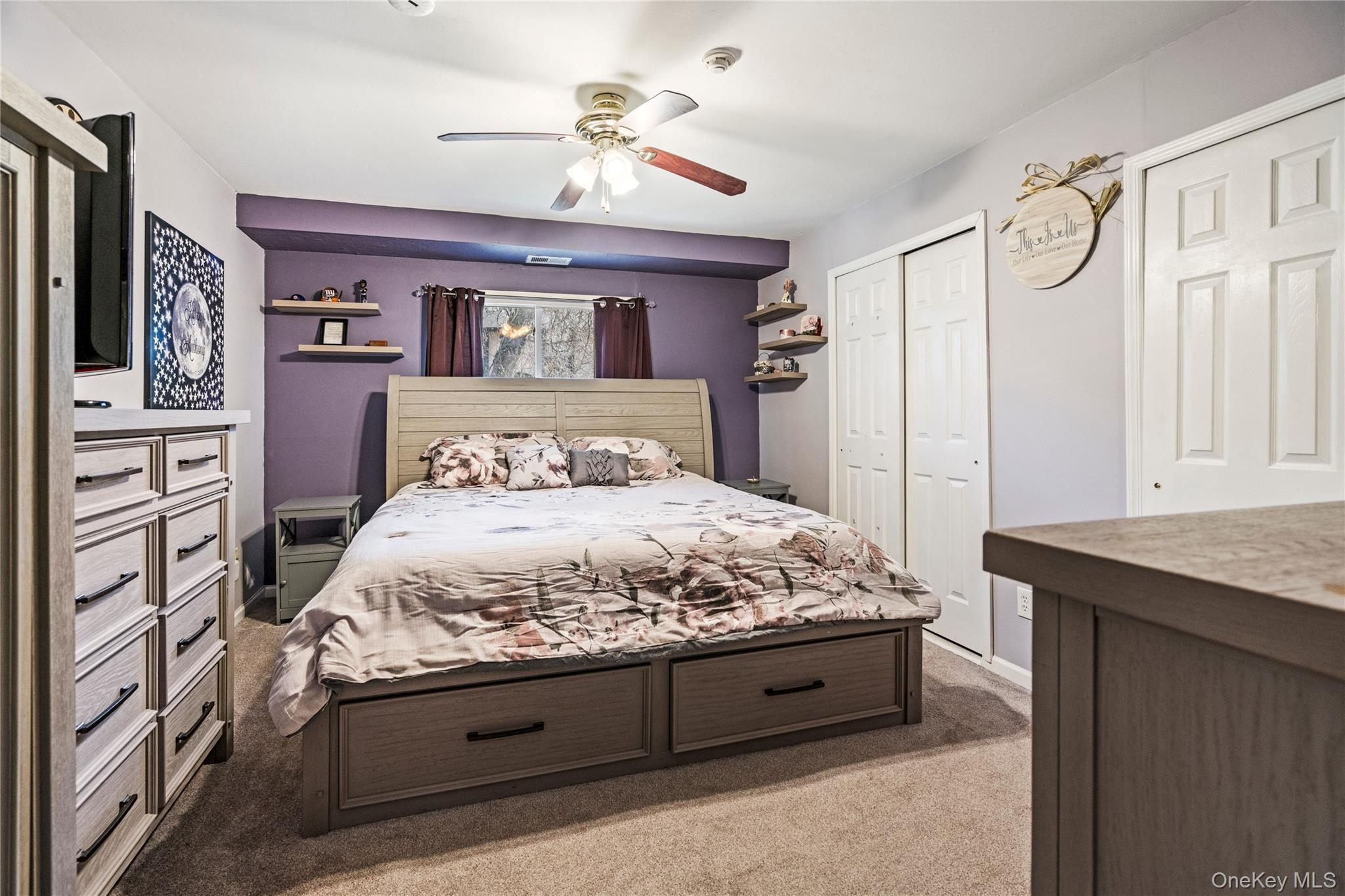 7 Maple Court, Unit 7 Selden, NY 11784 - Photo 16 of 18 a bedroom with a large bed and a dresser
