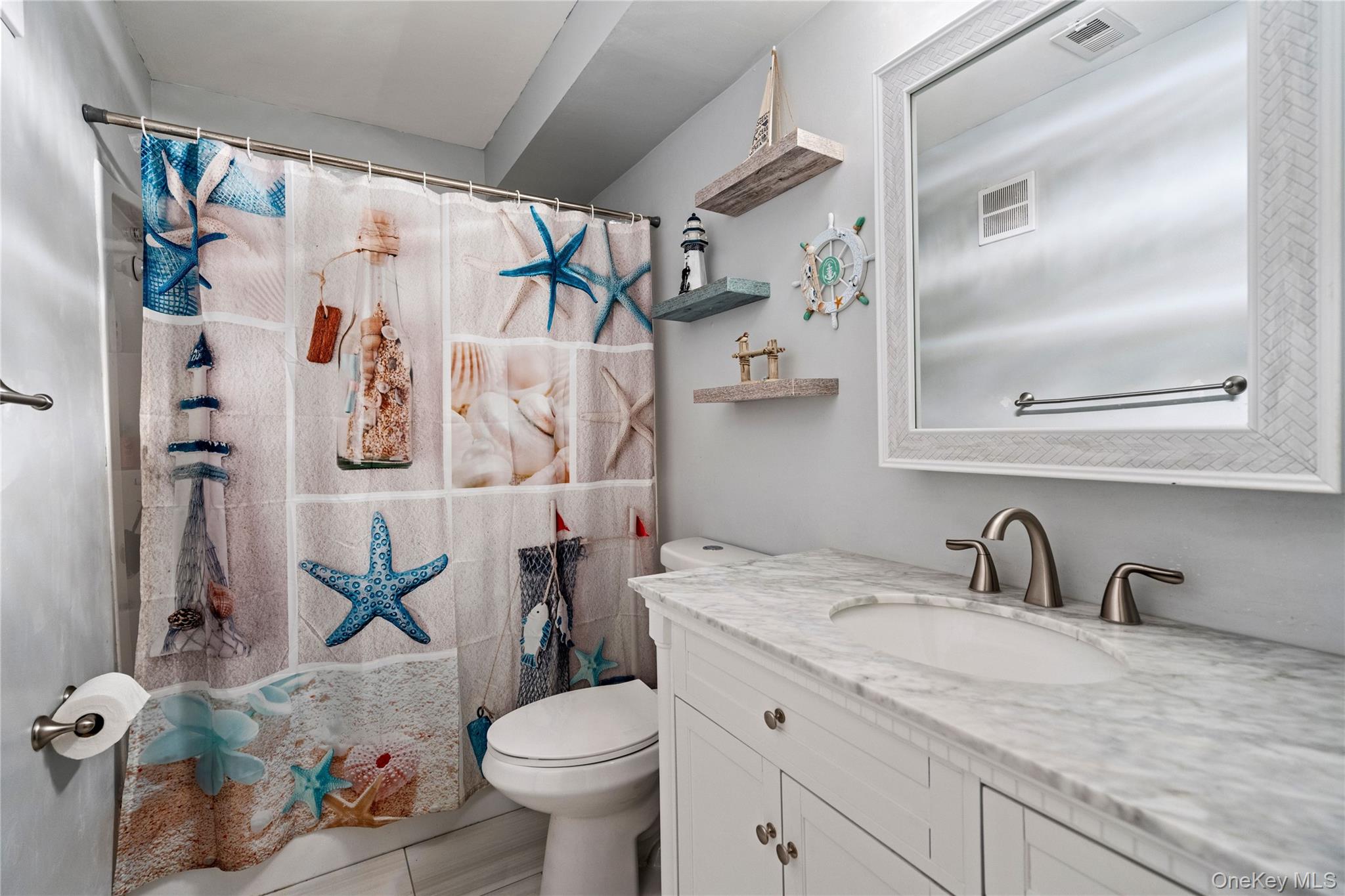 7 Maple Court, Unit 7 Selden, NY 11784 - Photo 17 of 18 a bathroom with a granite countertop sink and a mirror
