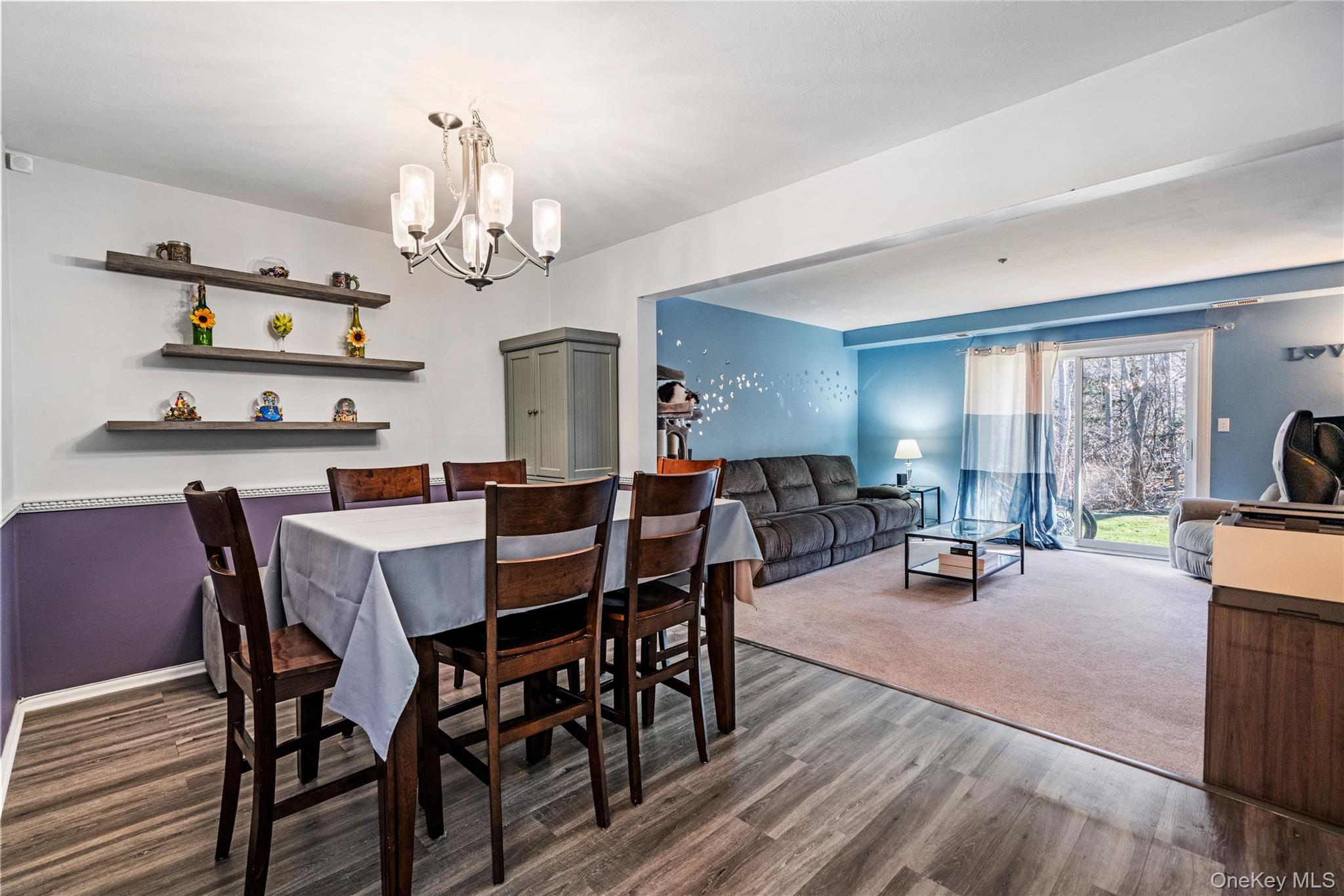 7 Maple Court, Unit 7 Selden, NY 11784 - Photo 7 of 18 a view of a dining room with furniture a chandelier and wooden floor