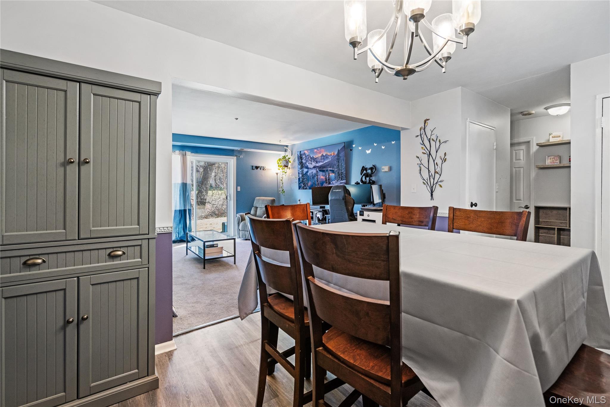 7 Maple Court, Unit 7 Selden, NY 11784 - Photo 9 of 18 a view of a dining room with furniture and a chandelier