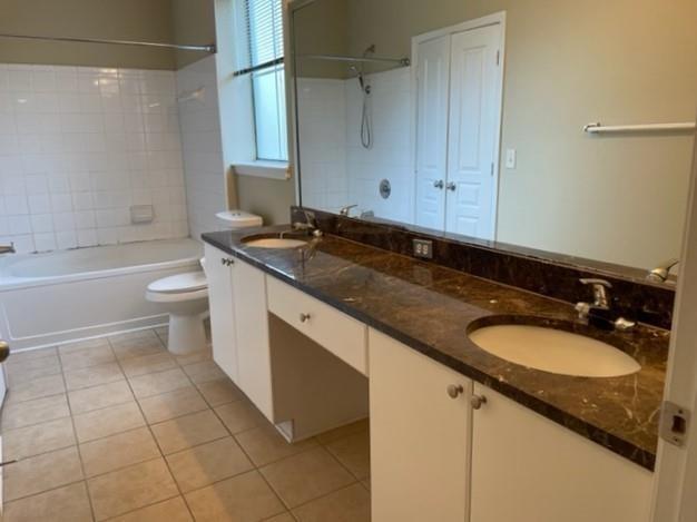 10 Perimeter Summit Boulevard, Unit 1310 Atlanta, GA 30319 - Photo 11 of 24 a bathroom with a granite countertop sink toilet a mirror and bathtub