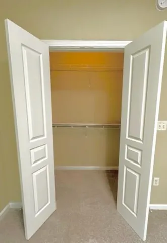 a bathroom with a granite countertop toilet sink and mirror