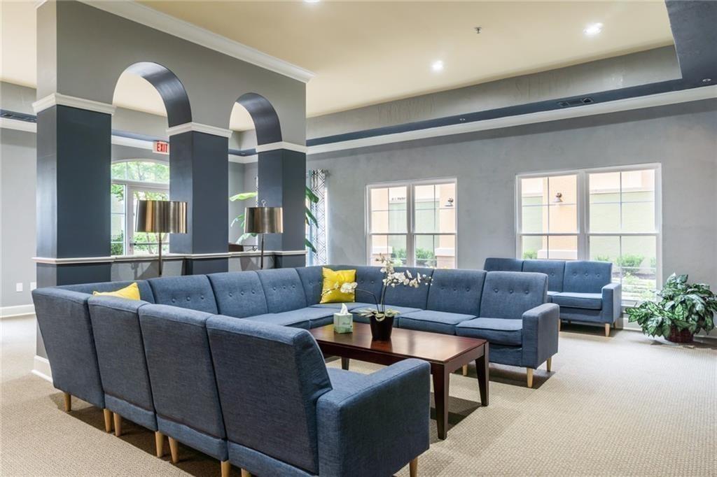 10 Perimeter Summit Boulevard, Unit 1310 Atlanta, GA 30319 - Photo 23 of 24 a living room with furniture and a large window