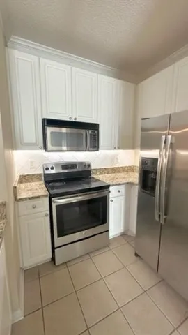 a kitchen with appliances cabinets and a sink
