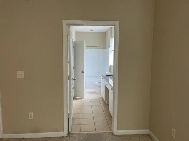 a view of a bathroom from a hallway