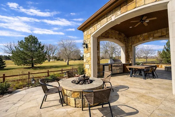 a view of a patio with table and chairs and potted plants