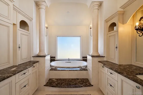 a bathroom with sink granite and a bathtub