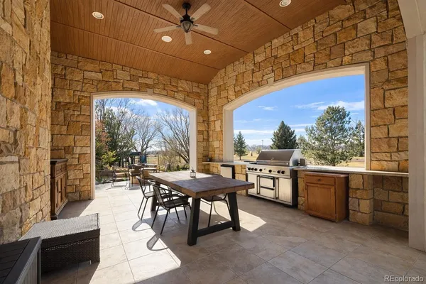 a dining room with a sink a stove and a fireplace