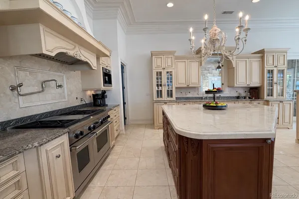 a kitchen with stainless steel appliances granite countertop a sink a stove and a wooden floors