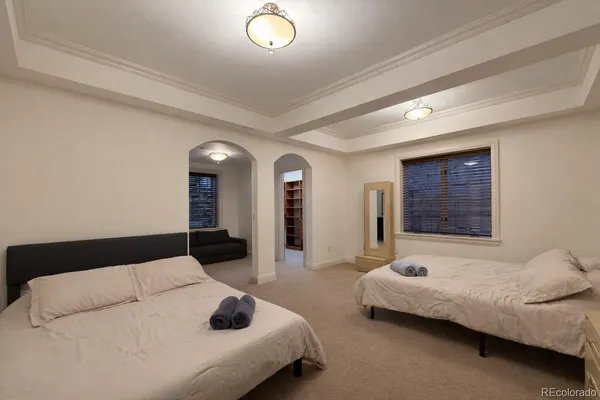a bedroom with a large bed and a chandelier