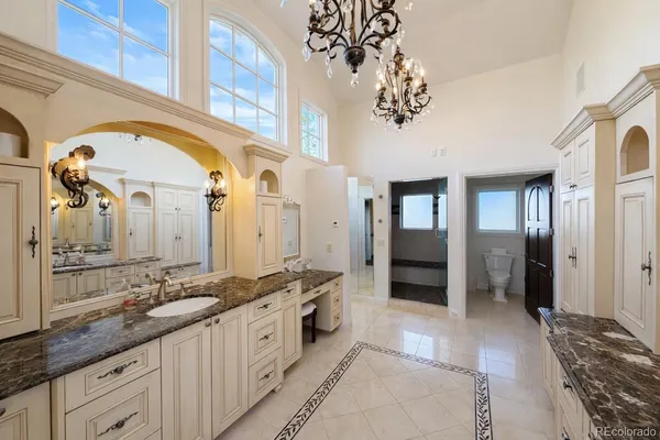 a spacious en suite bathroom with a double vanity sink and a mirror