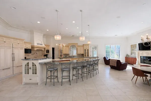 a kitchen with stainless steel appliances kitchen island granite countertop a table and chairs in it