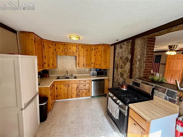 a kitchen with a stove a refrigerator and a sink