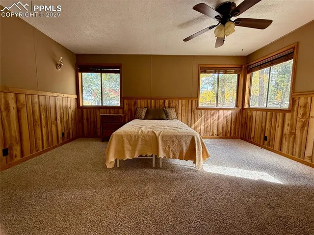 a bed sitting in a room next to a window