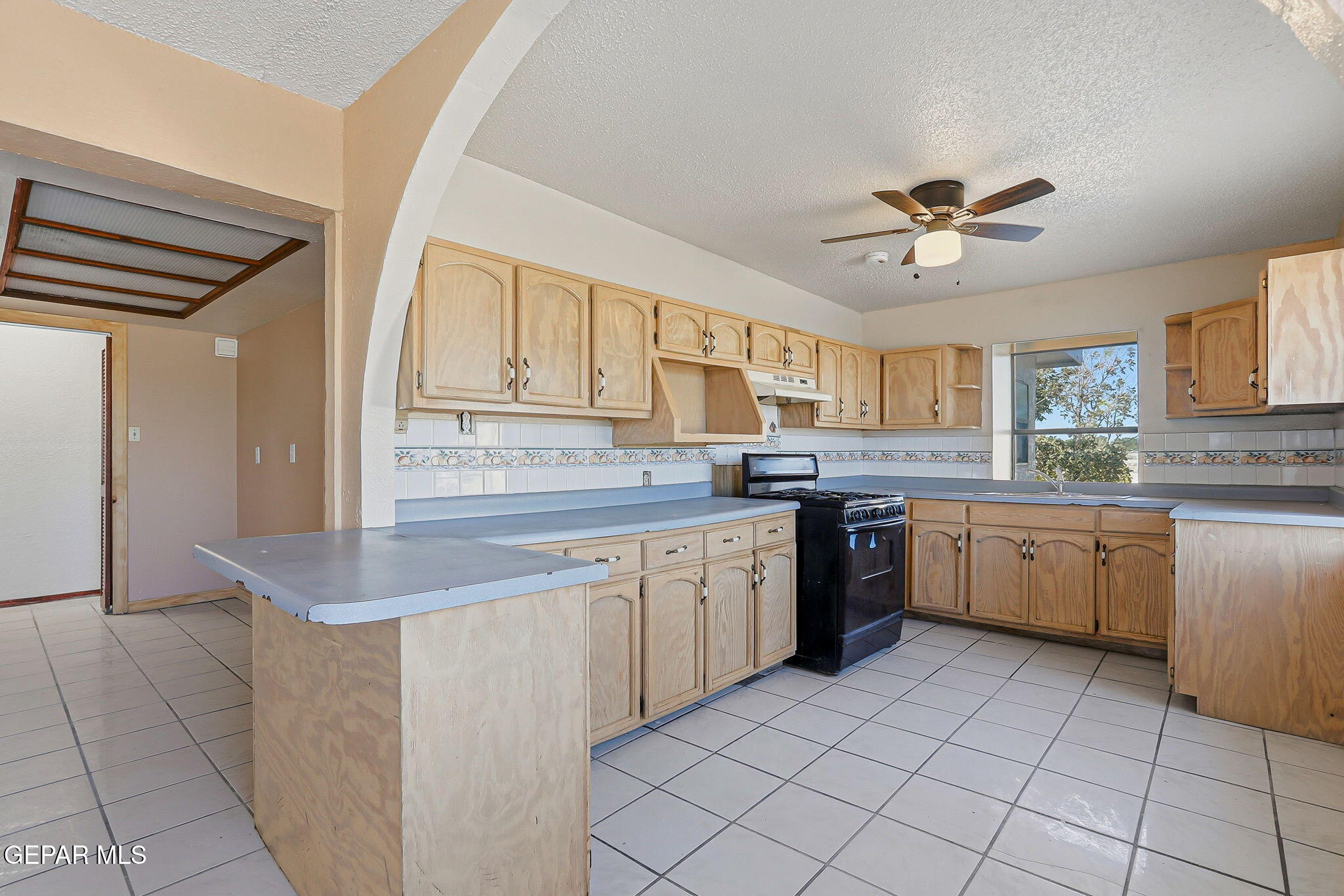 14573 B Van Fleet Road El Paso, TX 79938 - Photo 12 of 128 a kitchen with a sink window and cabinets