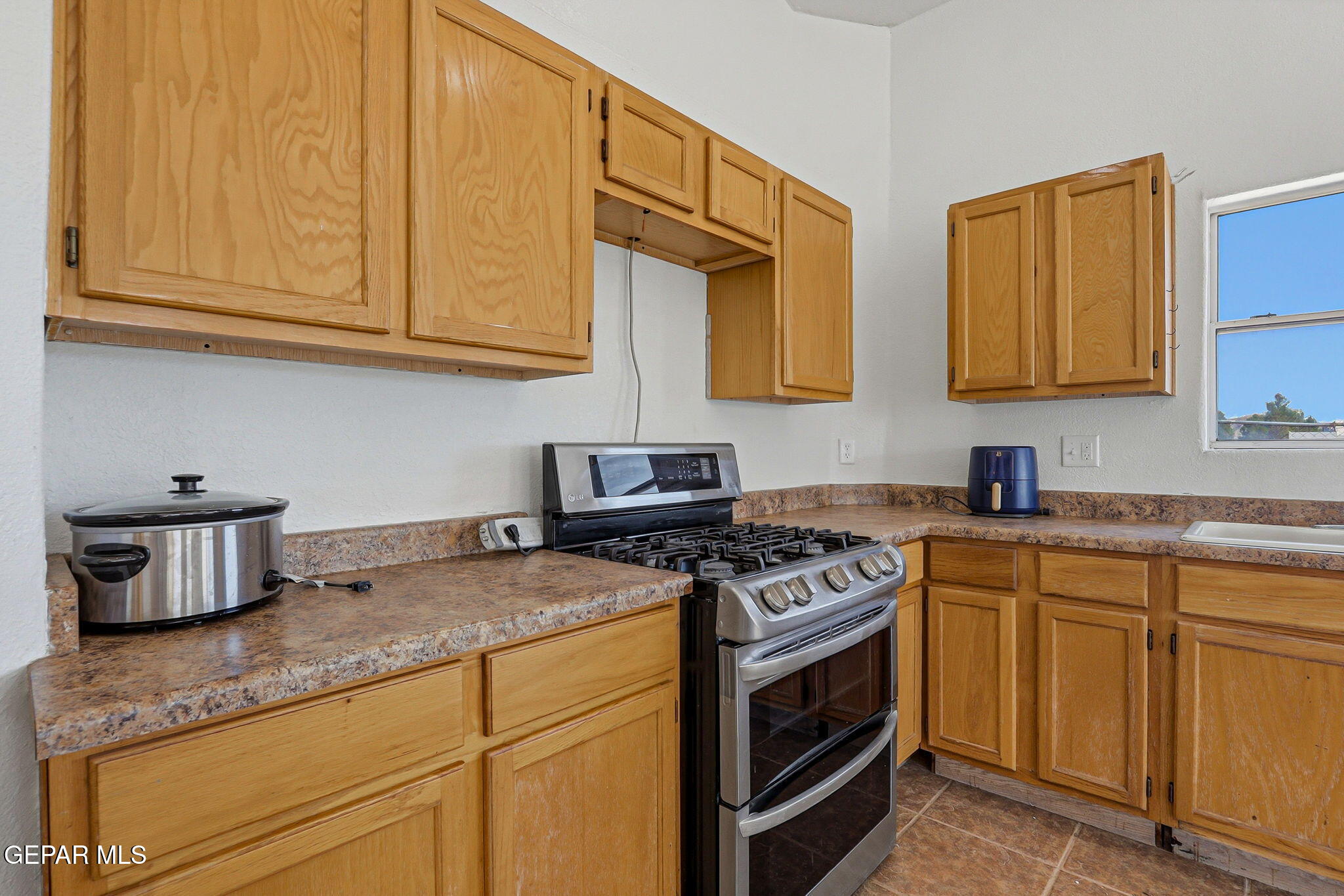 14573 B Van Fleet Road El Paso, TX 79938 - Photo 34 of 128 a kitchen with stainless steel appliances granite countertop a sink stove and cabinets