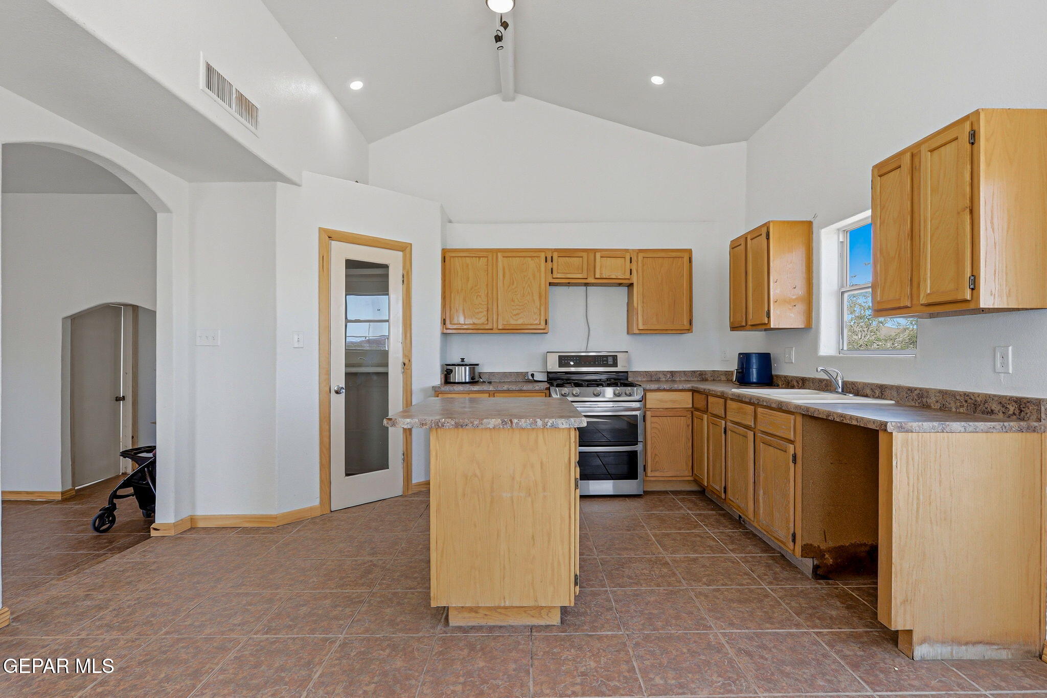 14573 B Van Fleet Road El Paso, TX 79938 - Photo 35 of 128 a kitchen with a refrigerator a sink and a stove top oven