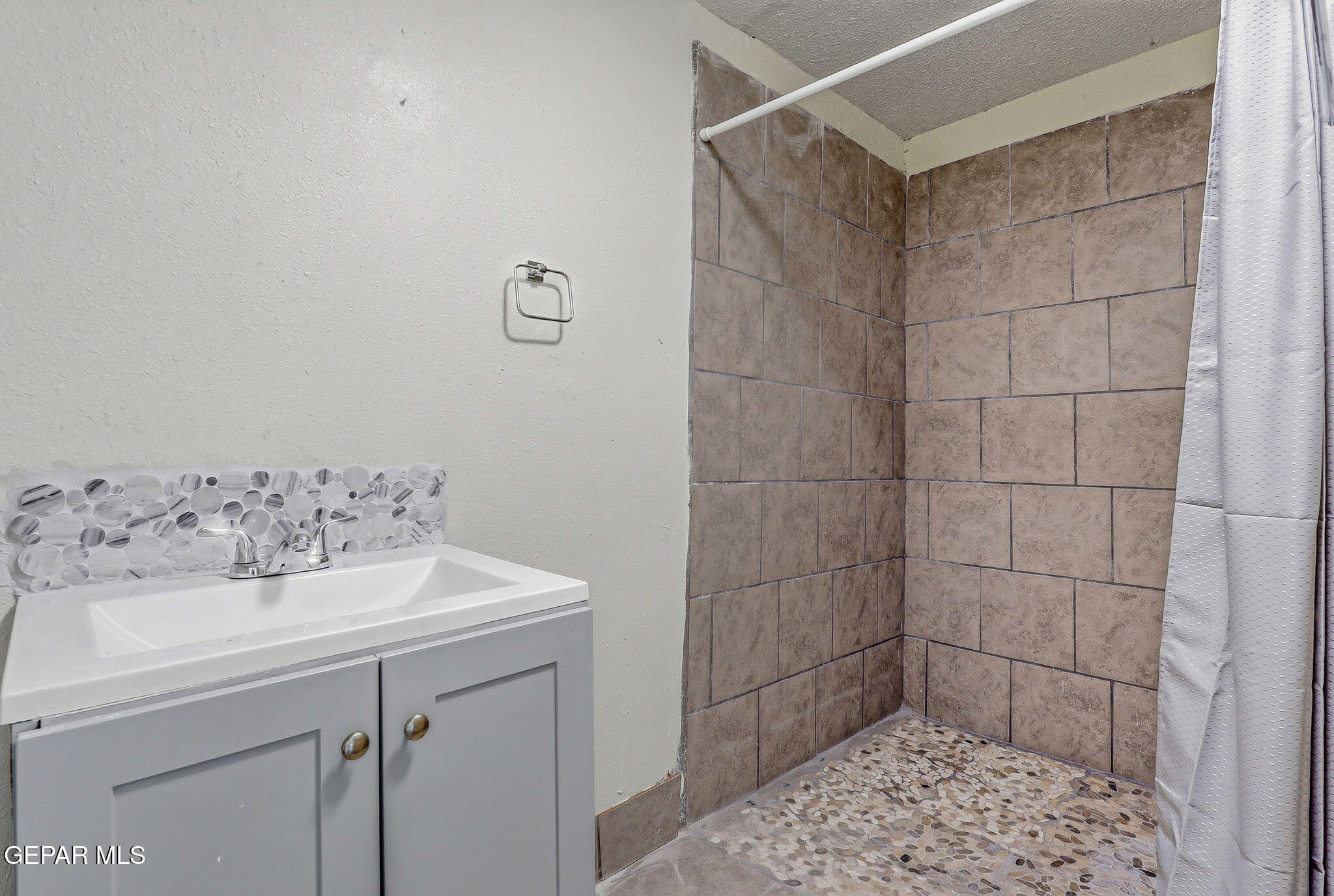 14573 B Van Fleet Road El Paso, TX 79938 - Photo 67 of 128 a bathroom with a sink and a shower