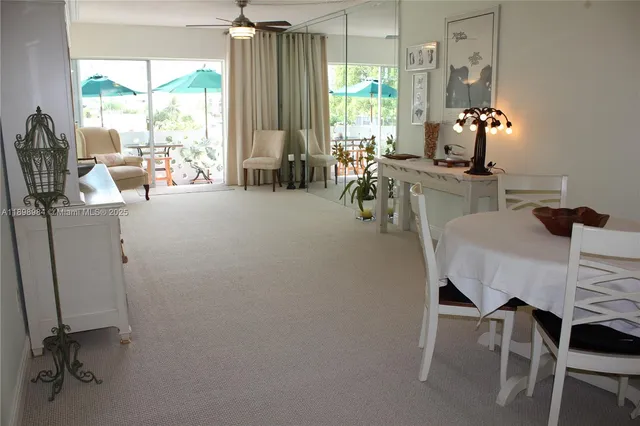 a living room with furniture a dining table and chairs