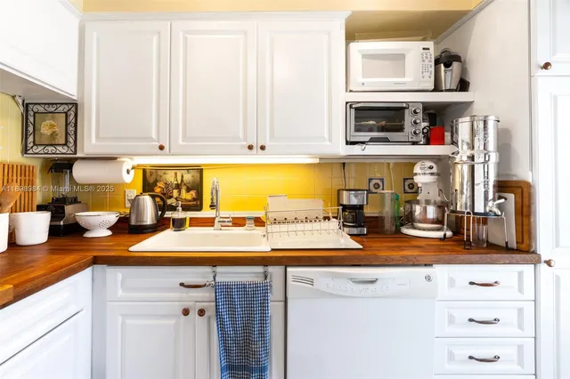 a view of a living room with furniture and a kitchen