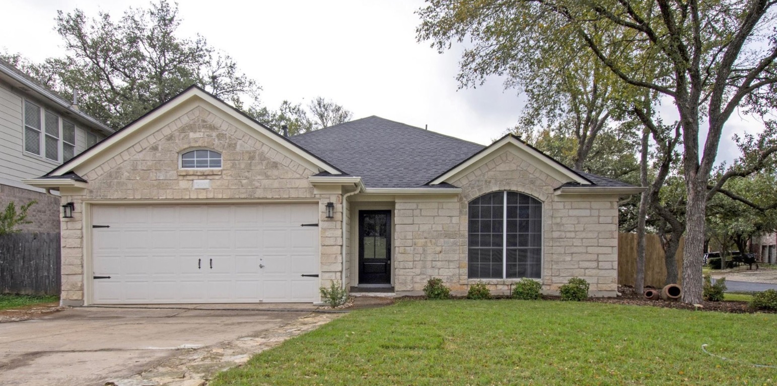 4900 Tiger Lily Way Austin, TX 78739 - Photo 1 of 1 a front view of a house with a yard and garage