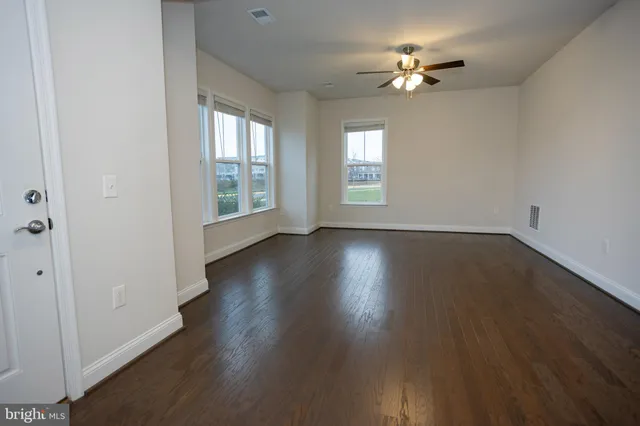 a kitchen with kitchen island a sink a stove and a refrigerator