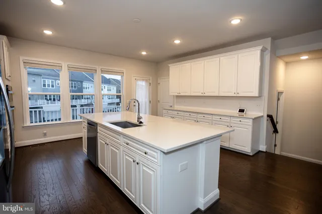 a kitchen with stainless steel appliances a refrigerator sink and cabinets