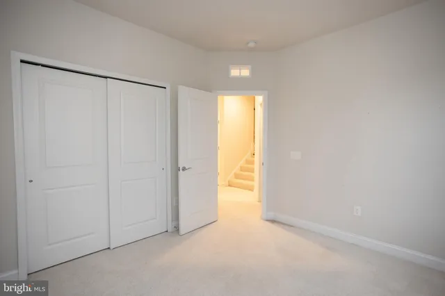 a view of an empty room with window and fireplace