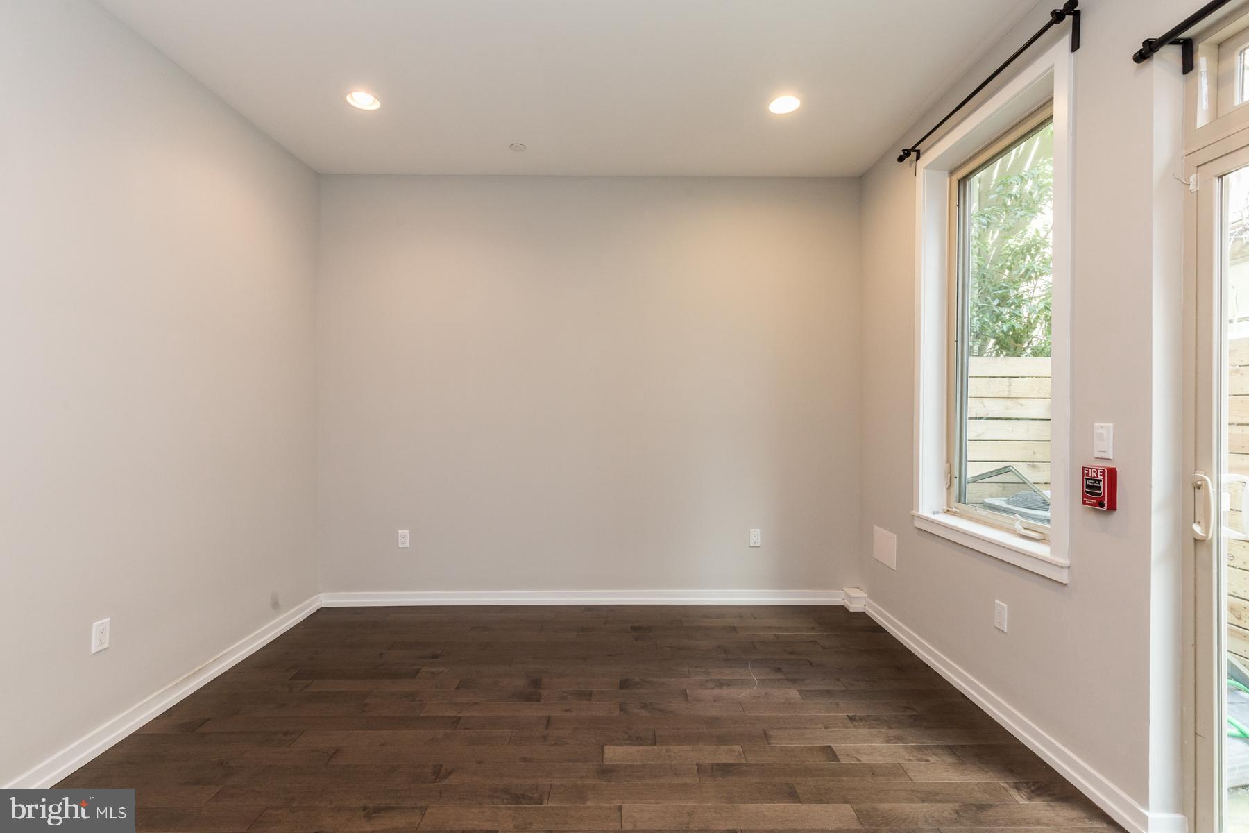 1815 Ranstead Street, Unit 1 Philadelphia, PA 19103 - Photo 11 of 27 an empty room with wooden floor and windows
