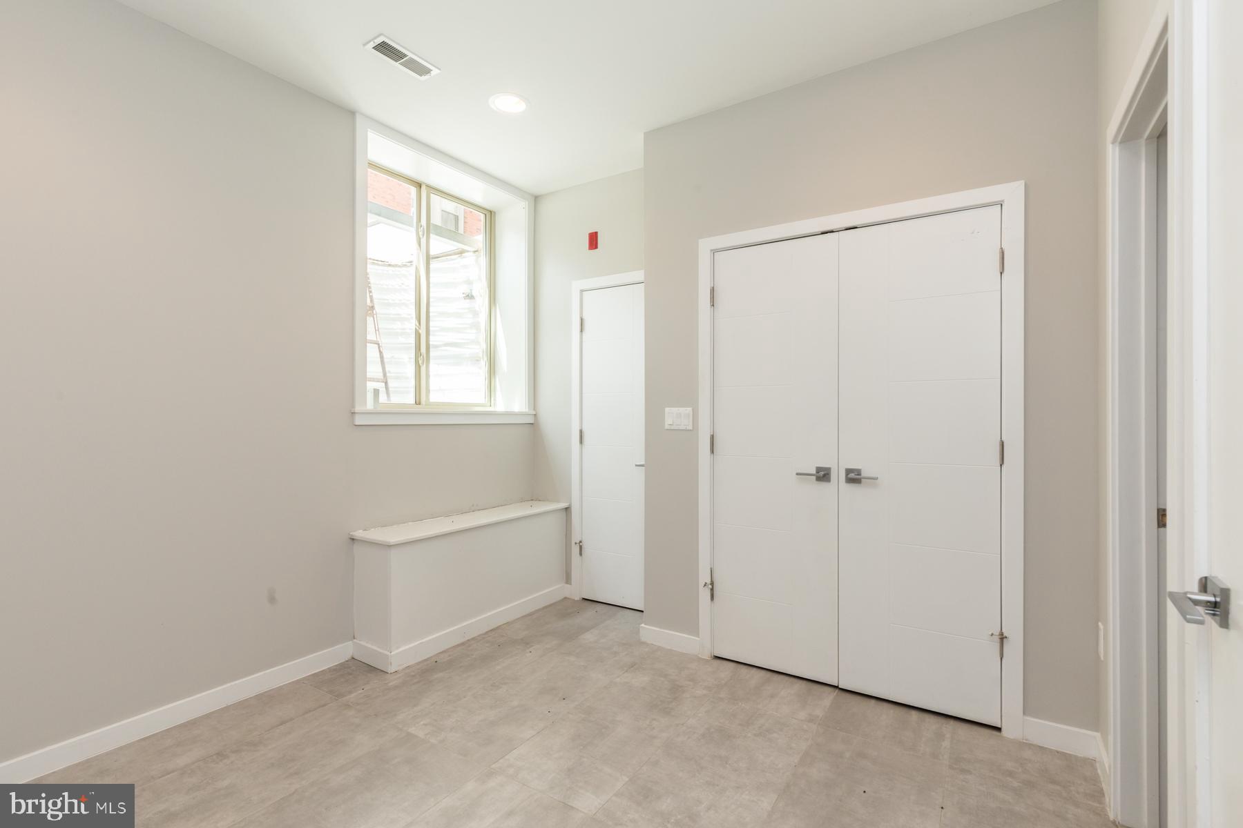 1815 Ranstead Street, Unit 1 Philadelphia, PA 19103 - Photo 15 of 27 a view of an empty room with a window