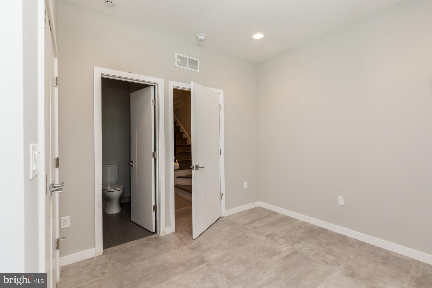 1815 Ranstead Street, Unit 1 Philadelphia, PA 19103 - Photo 16 of 27 an empty room with closet and windows