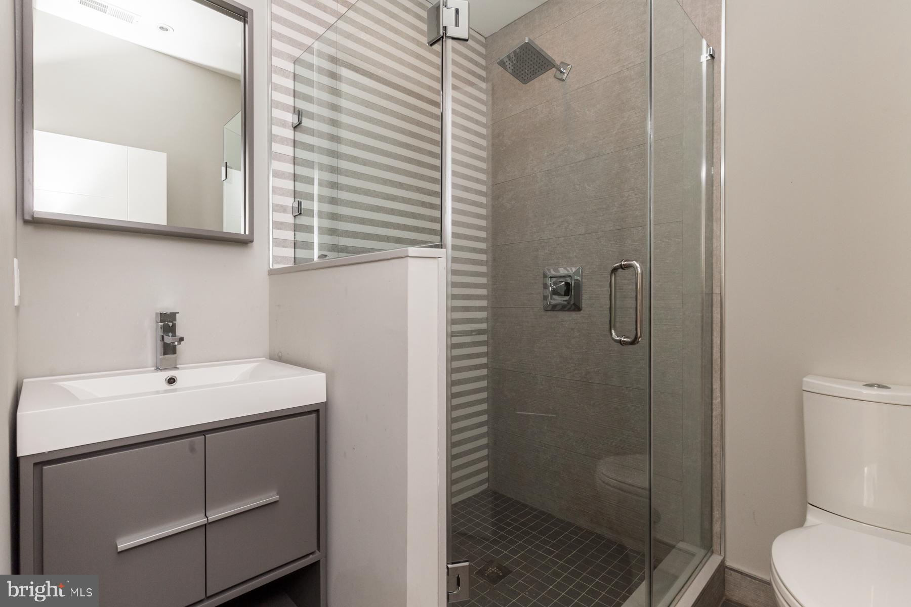 1815 Ranstead Street, Unit 1 Philadelphia, PA 19103 - Photo 17 of 27 a bathroom with a sink toilet and shower