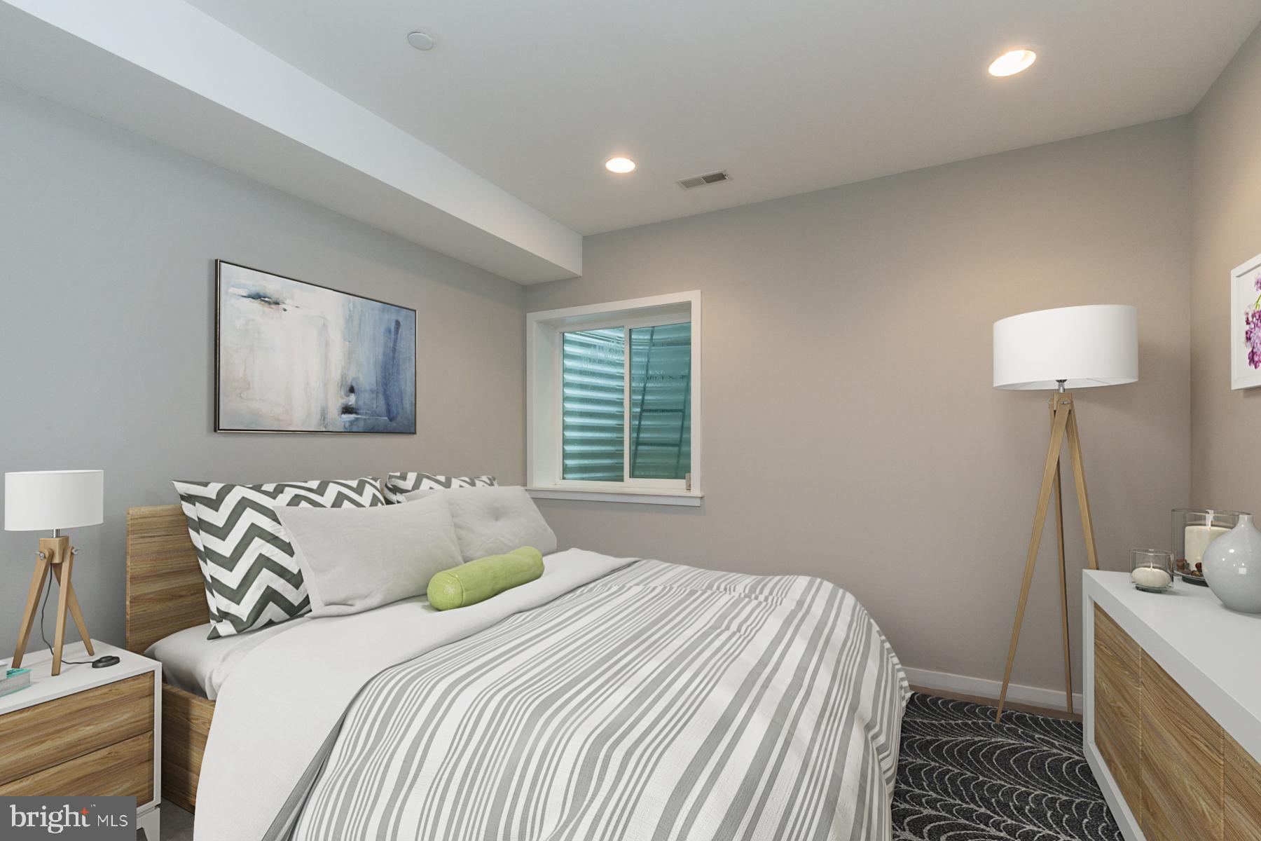 1815 Ranstead Street, Unit 1 Philadelphia, PA 19103 - Photo 20 of 27 a bedroom with a bed and a lamp