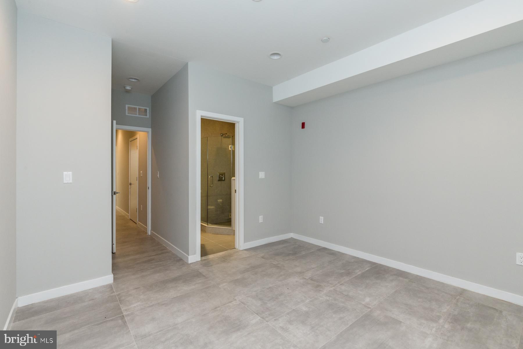 1815 Ranstead Street, Unit 1 Philadelphia, PA 19103 - Photo 21 of 27 an empty room with closet and wooden door