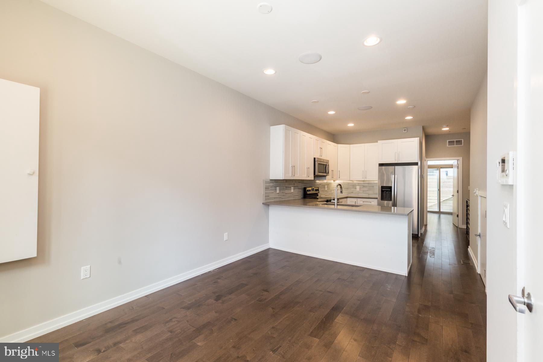 1815 Ranstead Street, Unit 1 Philadelphia, PA 19103 - Photo 3 of 27 a kitchen with a refrigerator and a stove top oven