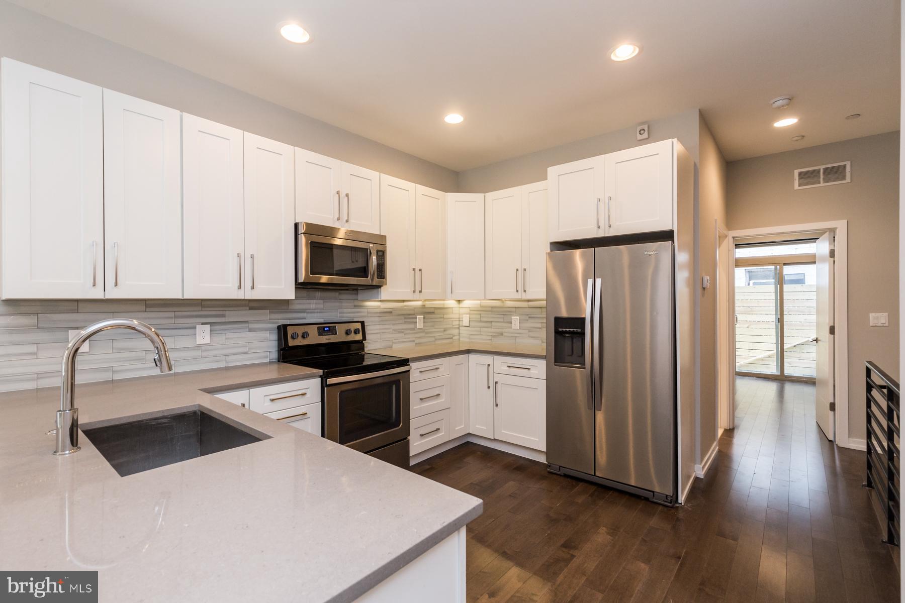 1815 Ranstead Street, Unit 1 Philadelphia, PA 19103 - Photo 4 of 27 a kitchen with granite countertop a refrigerator stove and sink