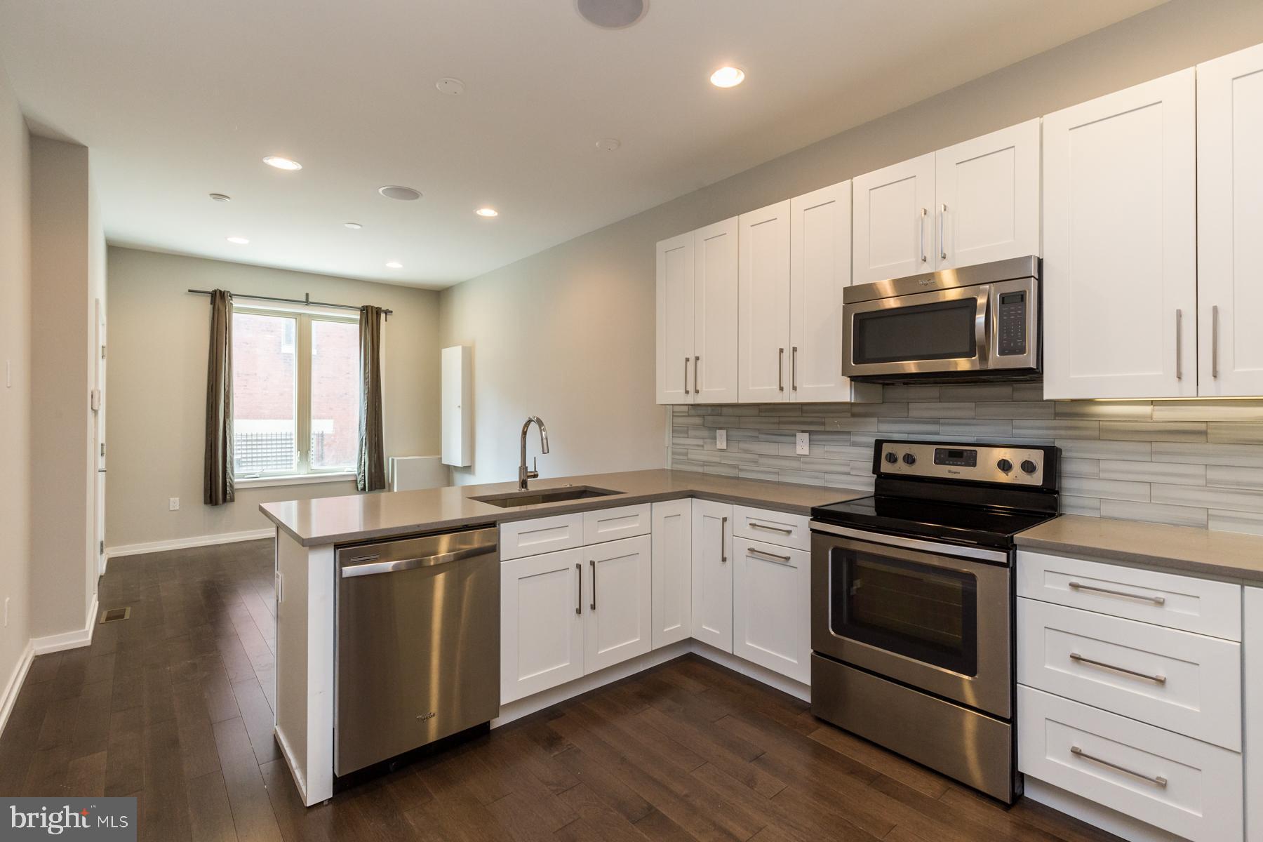 1815 Ranstead Street, Unit 1 Philadelphia, PA 19103 - Photo 6 of 27 a kitchen with stainless steel appliances granite countertop a stove and a sink