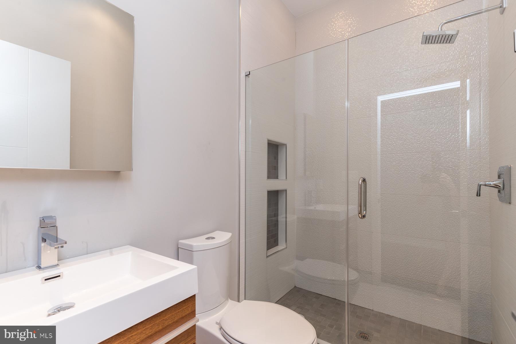 1815 Ranstead Street, Unit 1 Philadelphia, PA 19103 - Photo 8 of 27 a bathroom with a sink toilet and shower