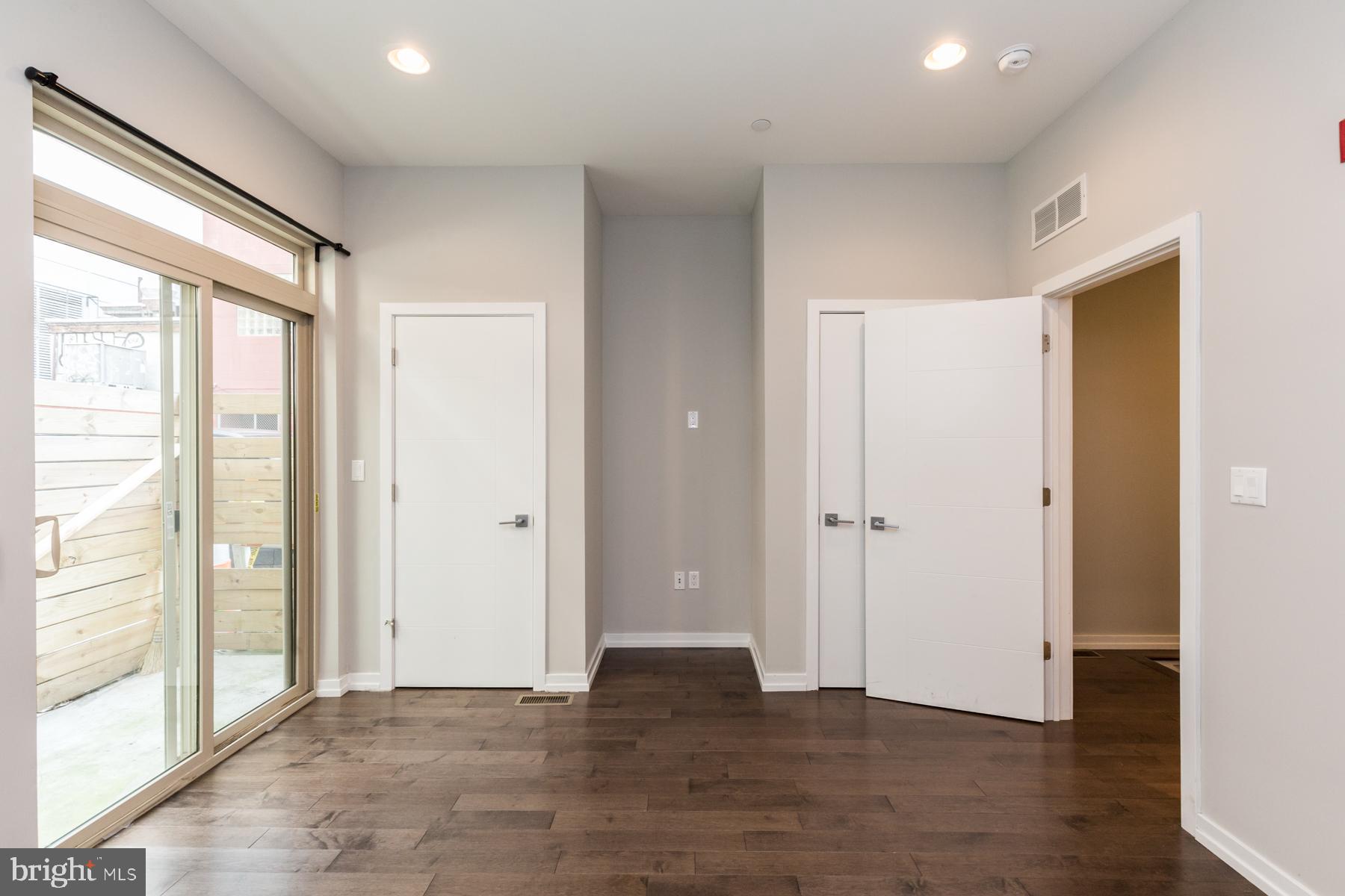 1815 Ranstead Street, Unit 1 Philadelphia, PA 19103 - Photo 10 of 27 a view of an empty room with wooden floor and a window