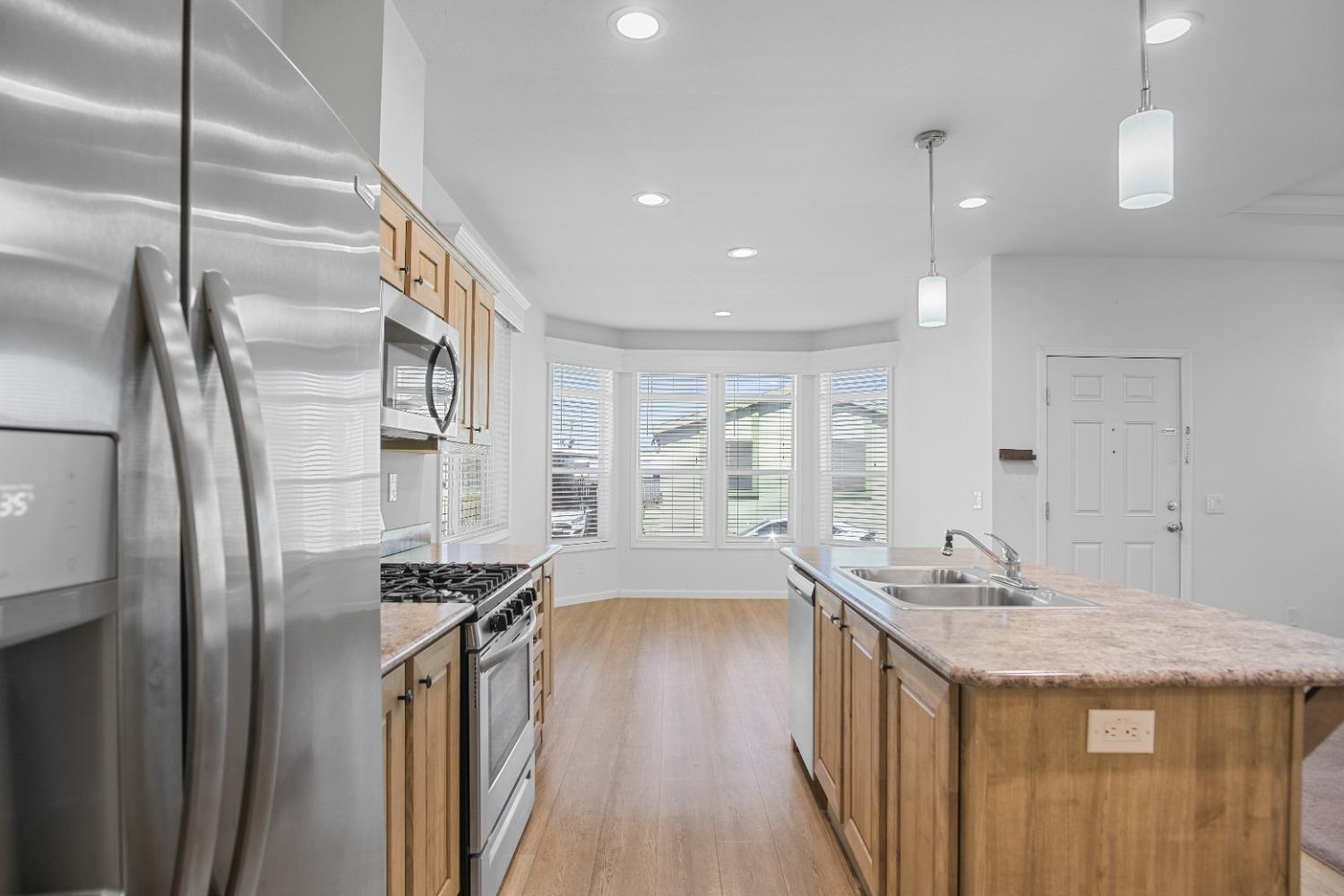 3524 Homestead Way, Unit 57 Ceres, CA 95307 - Photo 3 of 5 a kitchen with stainless steel appliances granite countertop a sink stove and refrigerator