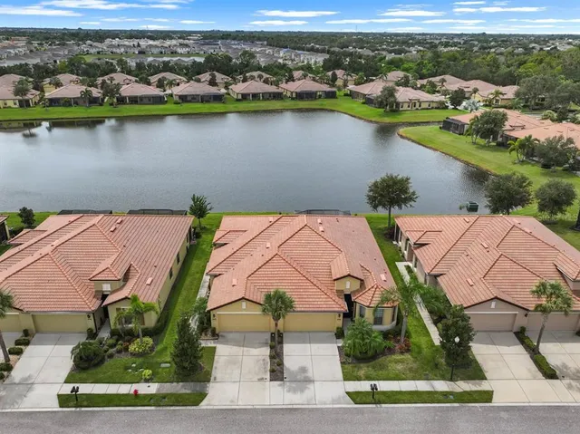 an aerial view of a house with a lake view