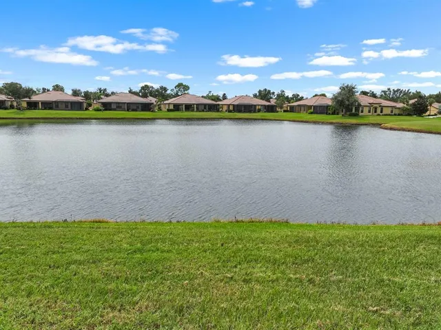 a view of a lake and houses in the back