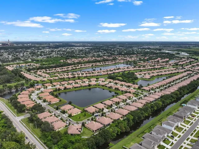 an aerial view of a house with a swimming pool yard and outdoor seating