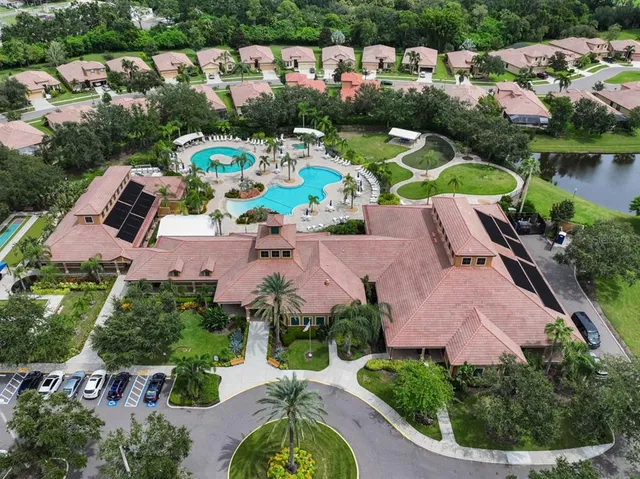 an aerial view of a house with yard swimming pool and outdoor seating