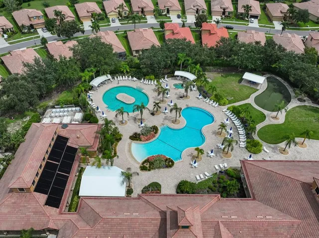 an aerial view of residential houses with outdoor space and parking