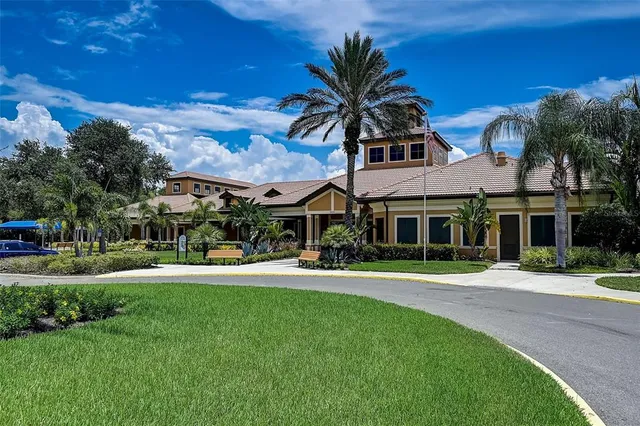 a view of a house with swimming pool and sitting area