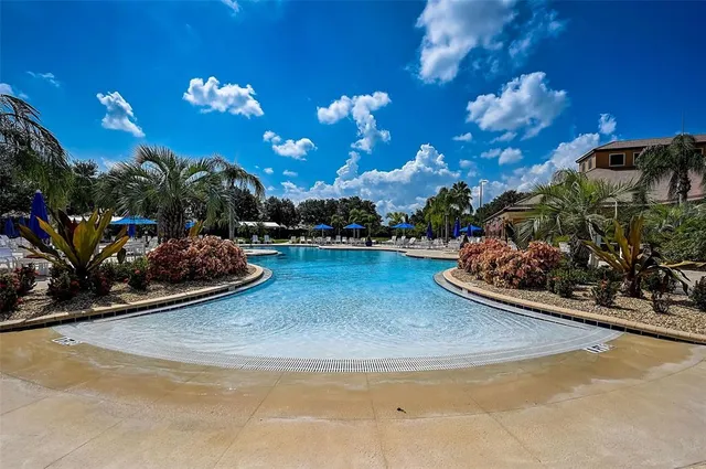 a view of swimming pool with outdoor seating