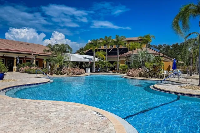 a view of a patio with chairs and table under an umbrella